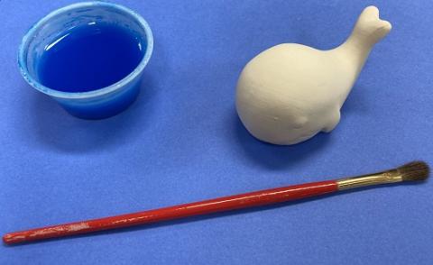 Blue paint, paint brush, ceramic whale