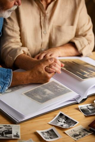 Two people sharing photos in a family photo album