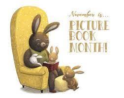 Large brown rabbit sitting in a yellow chair reading to two small bunnies with caption "November is Picture Book Month".